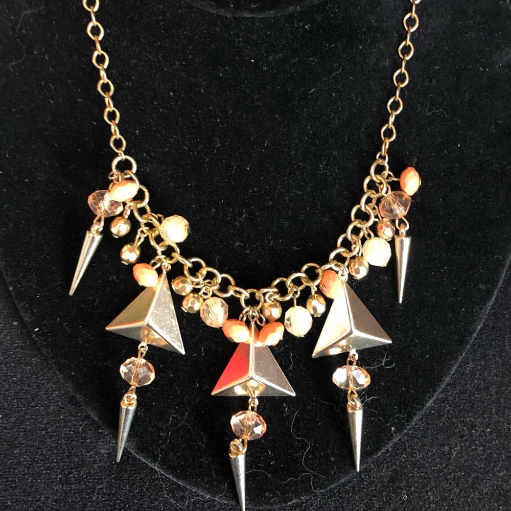 Gold-tone statement necklace with pink beads